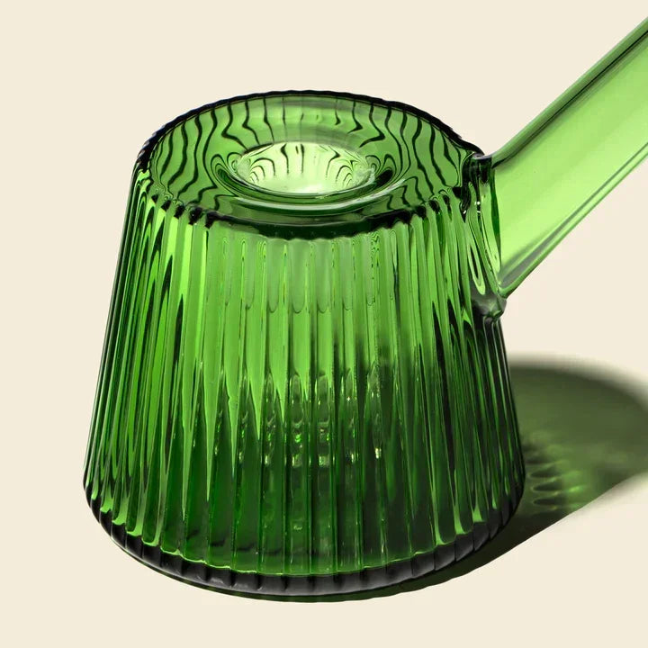 Emerald green ribbed glass bubbler with angled neck on light background