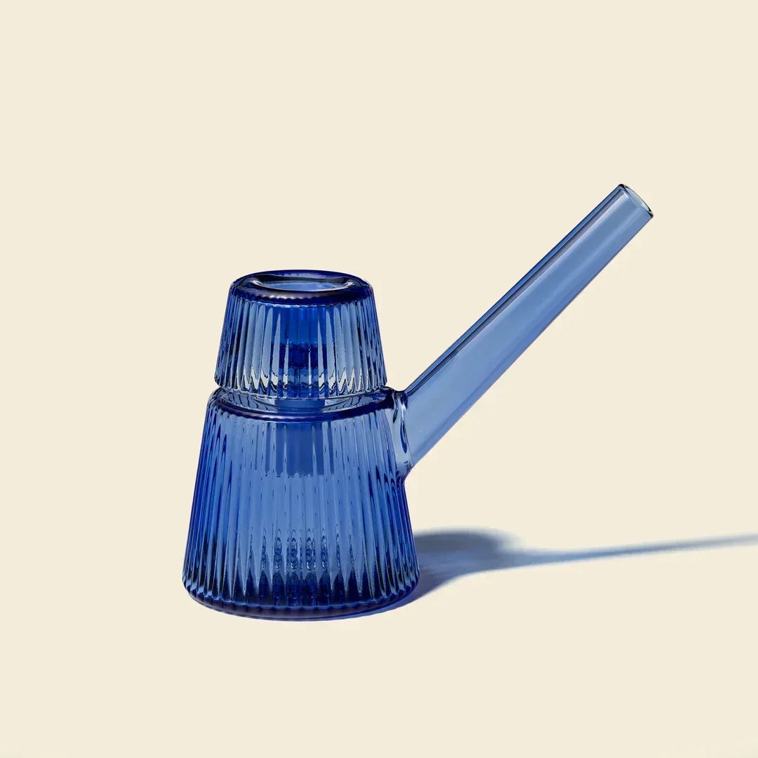 Blue glass bubbler pipe with ribbed texture on a plain background