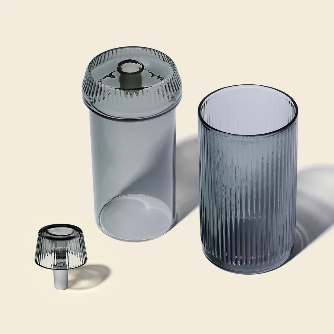 Charcoal gravity bong set with modern ribbed glass design on light background