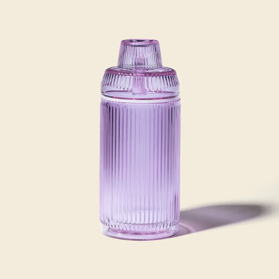 Orchid-purple ribbed glass gravity bong with modern design on a light background