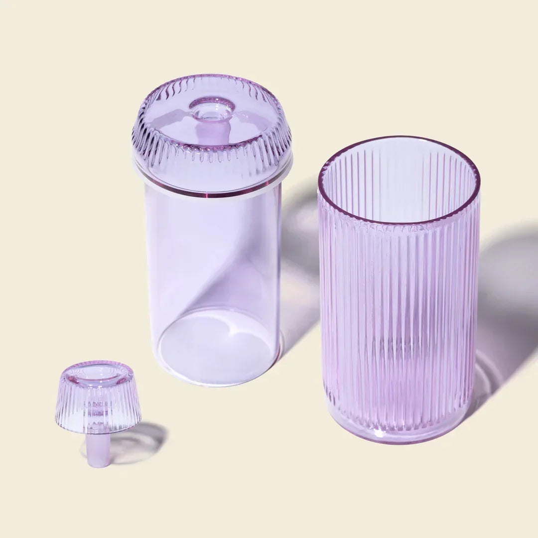 Orchid purple glass gravity bong set with ribbed texture on neutral background