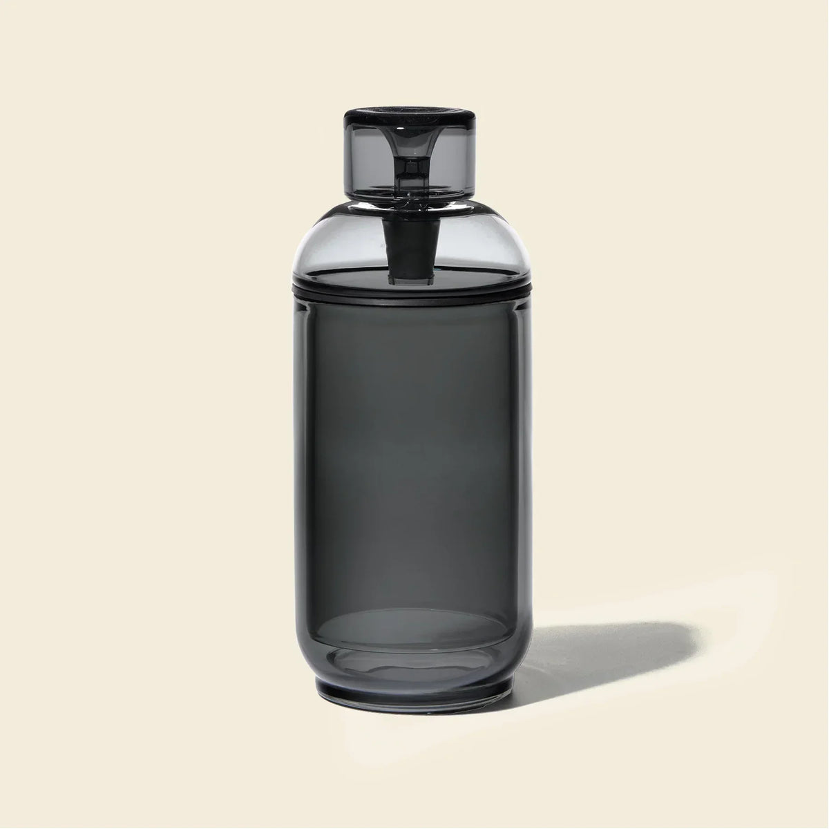Modern charcoal gray gravity bong with sleek glass design on a light background