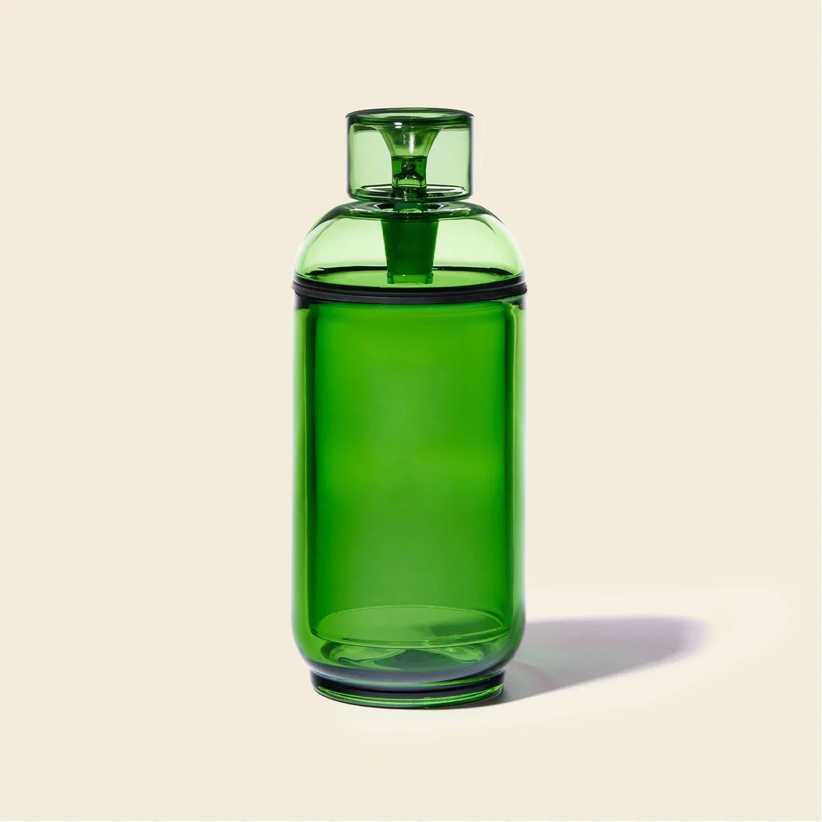 Emerald green glass gravity bong with modern design on beige background