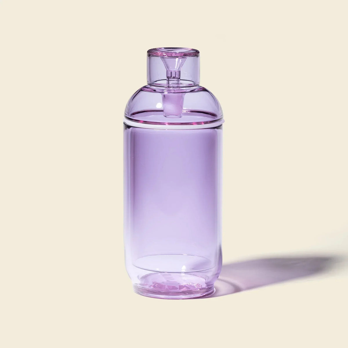 Orchid purple gravity bong with sleek glass design on beige background