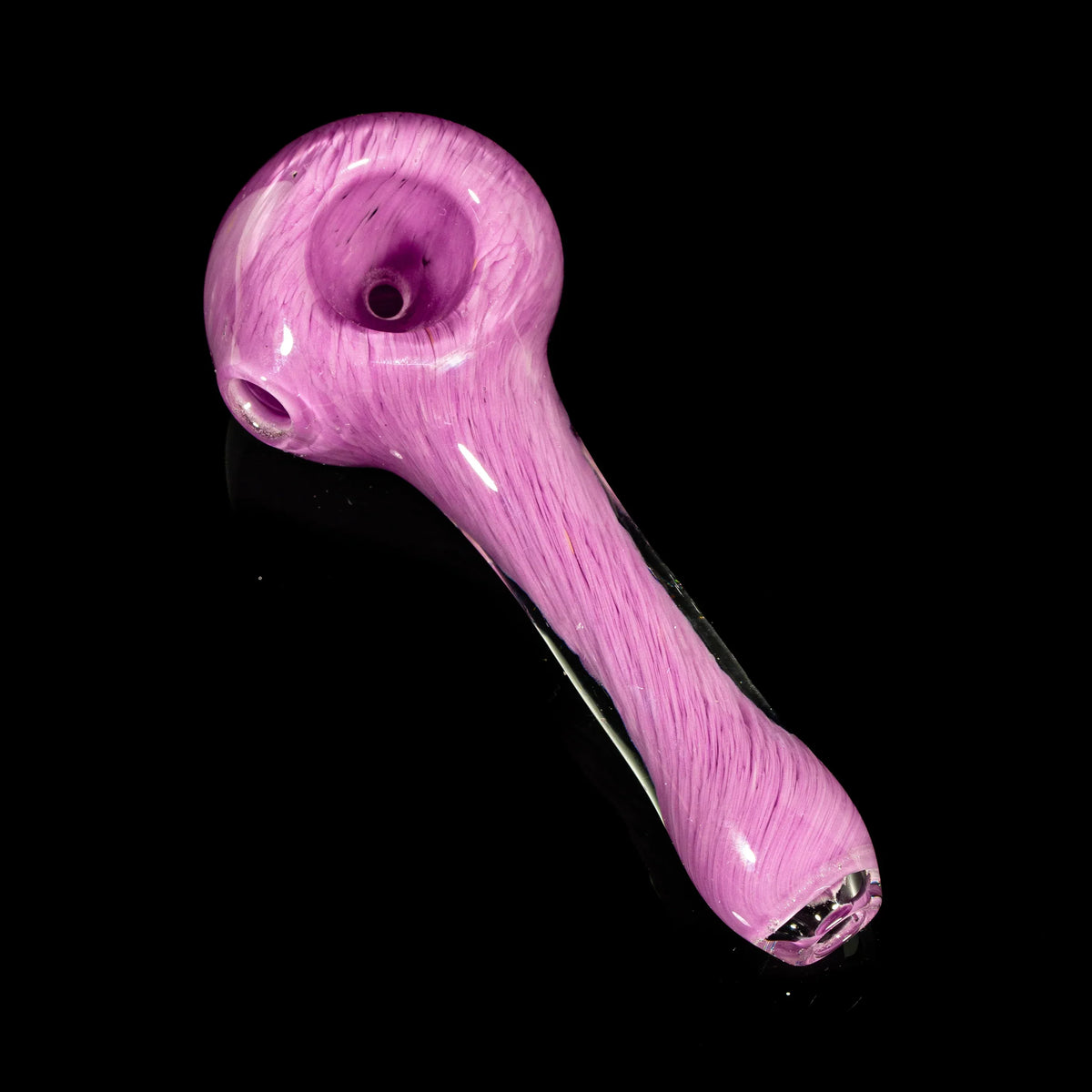 Pink glass hand pipe with colored frit design on a black background