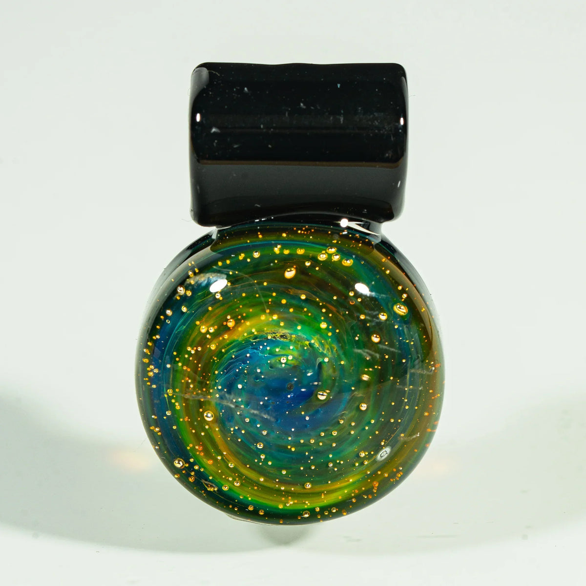 Handblown glass nebula pendant with swirling blue, green, and gold galaxy design