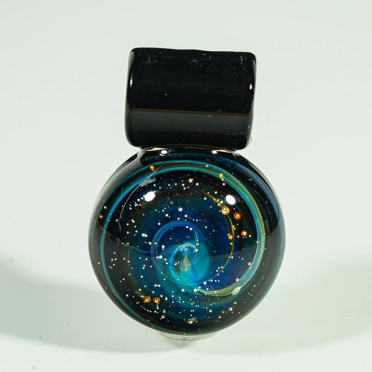 Handcrafted glass pendant with a galaxy nebula design, featuring swirling blue and gold details.