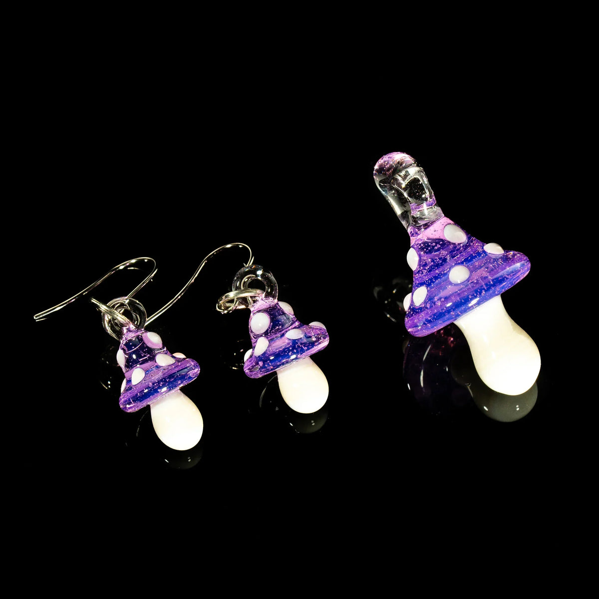 Purple mushroom glass pendant and earring set with white spots on black background