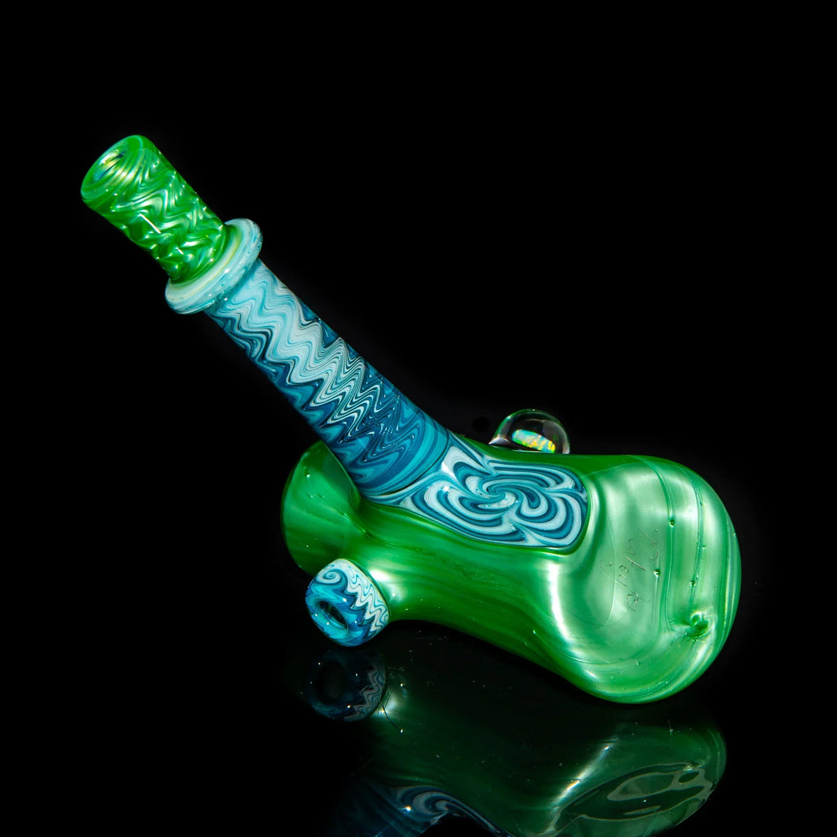 Green and blue linework glass hammer pipe with intricate patterns on black background