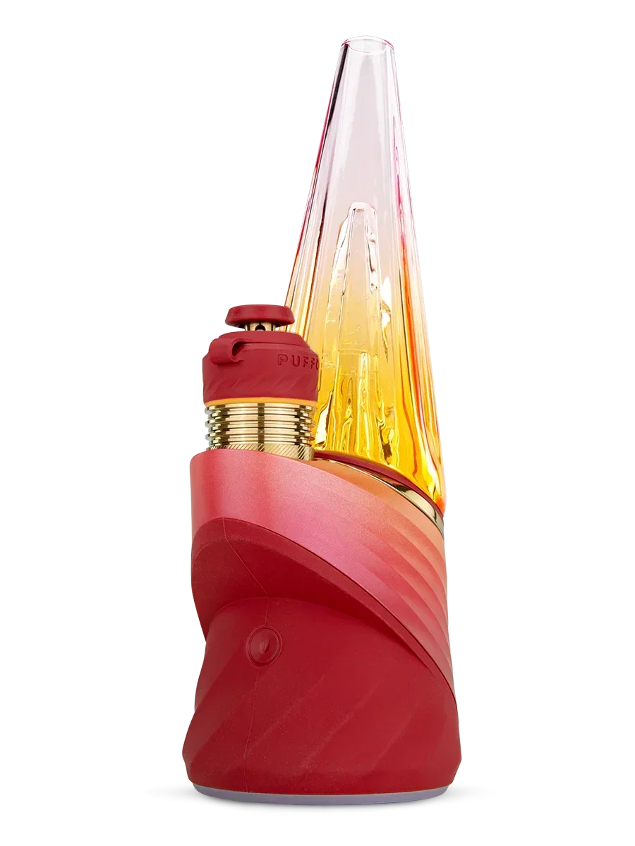 Peak Pro Daybreak vaporizer with red and yellow glass chamber, desktop view