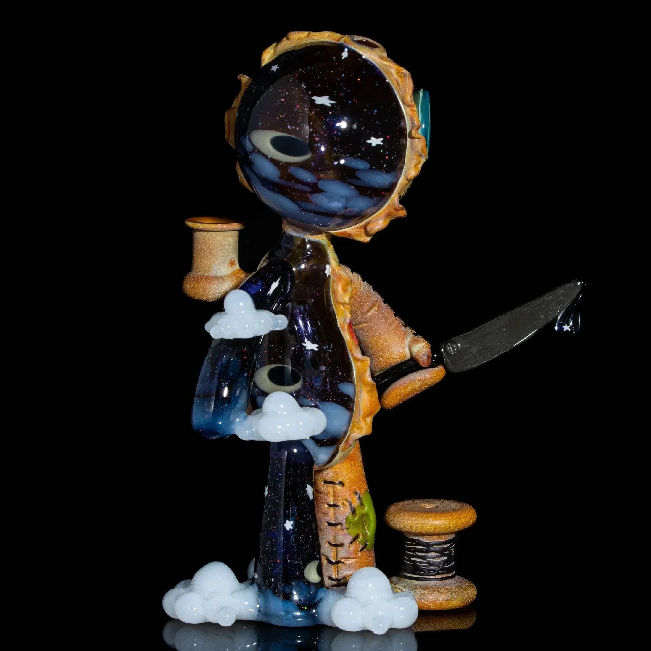 Heady glass art doll featuring cosmic galaxy elements, clouds, and spool details on black background.