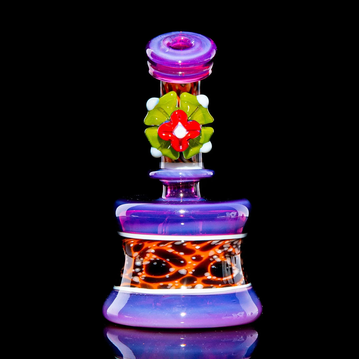 Colorful glass mini water pipe with purple, orange, and green flower accents on black background