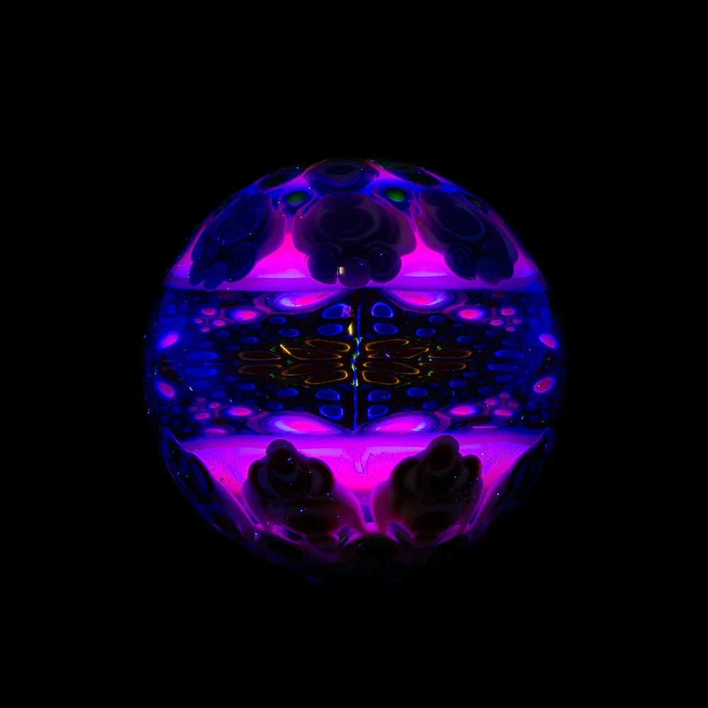 Heady glass art marble with vibrant purple and blue patterns, glowing on a black background