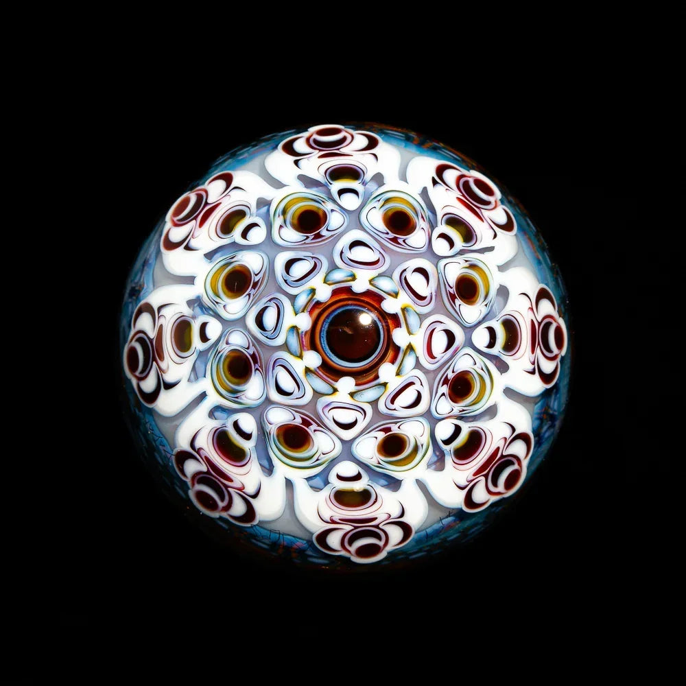 Colorful heady glass marble with intricate psychedelic pattern on black background