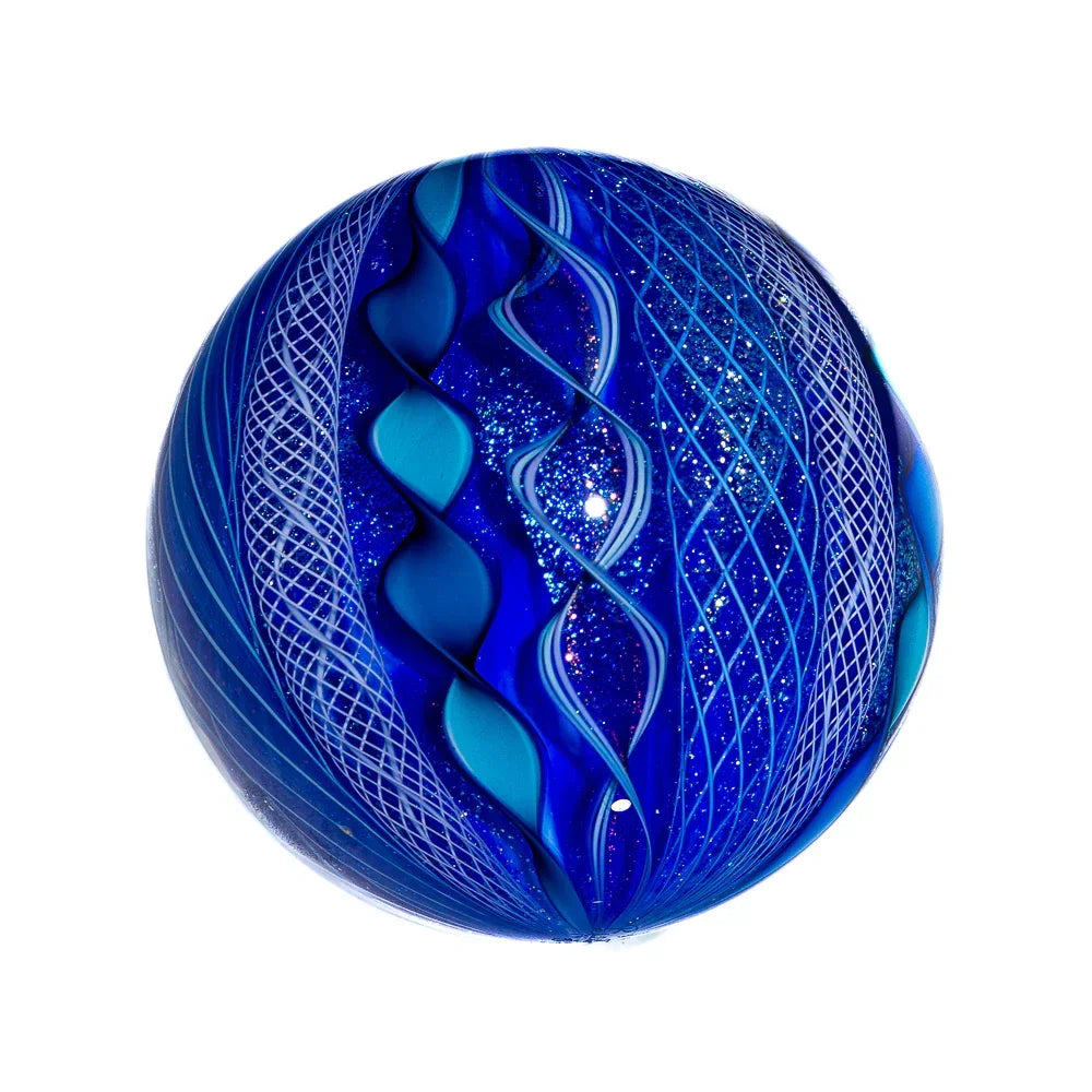 Hand-blown glass marble with swirling blue patterns and intricate white lattice design