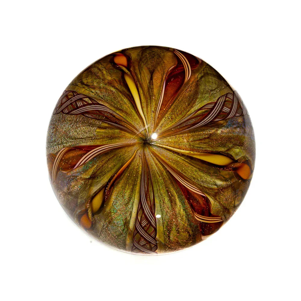 Handcrafted gold and amber art glass marble with intricate swirling patterns, top view.