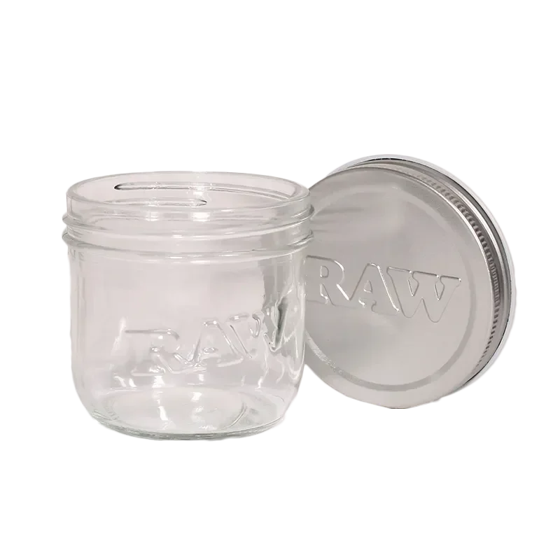 Clear glass storage jar with RAW logo and metal lid for herb or accessory storage