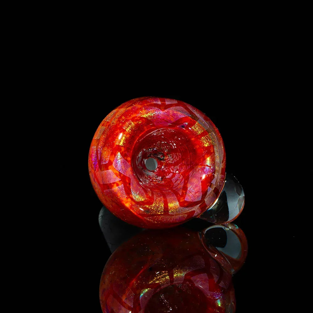 Hand-blown orange red glass slide with iridescent patterns on black background