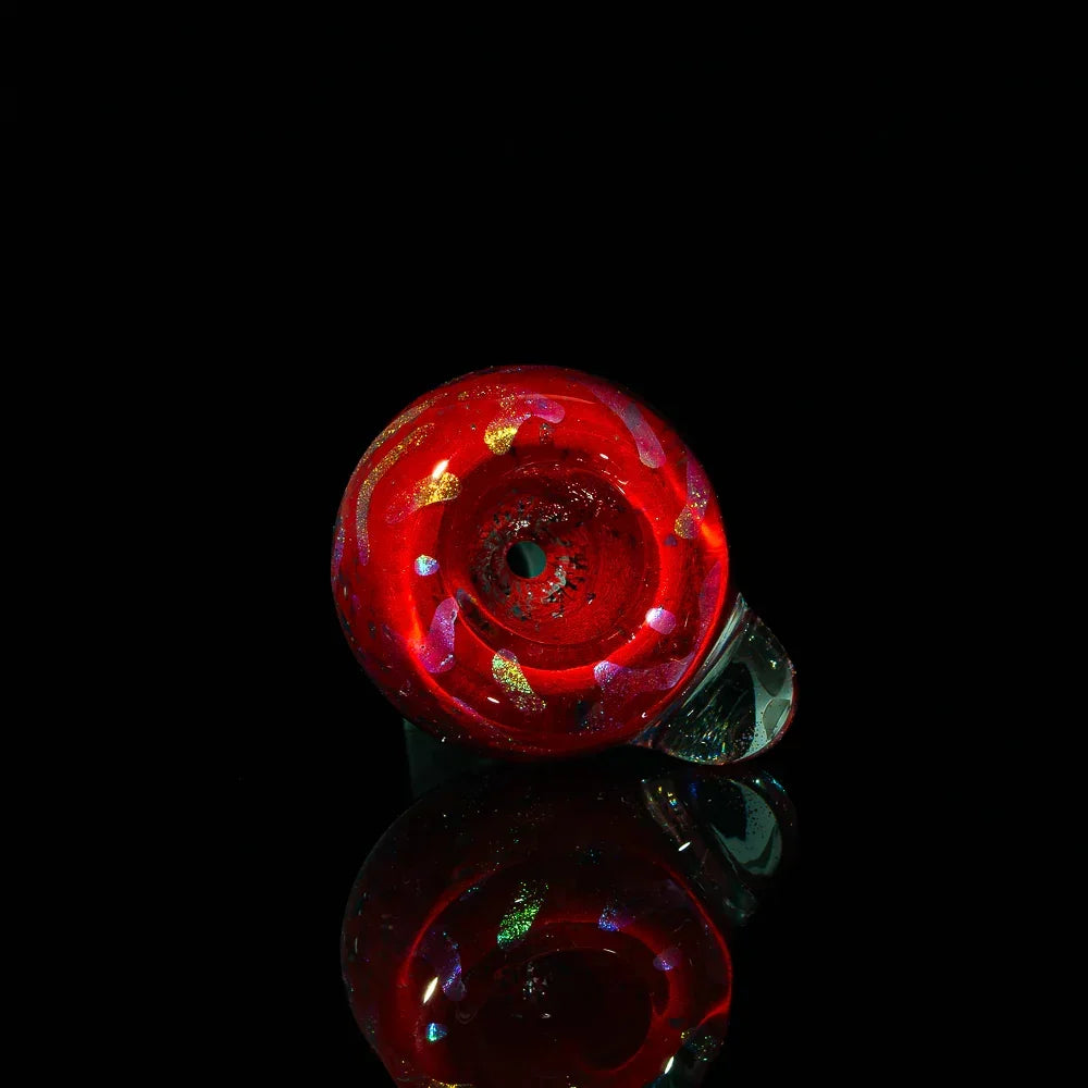 Red glass slide bowl with blue and gold squiggle accents on black background