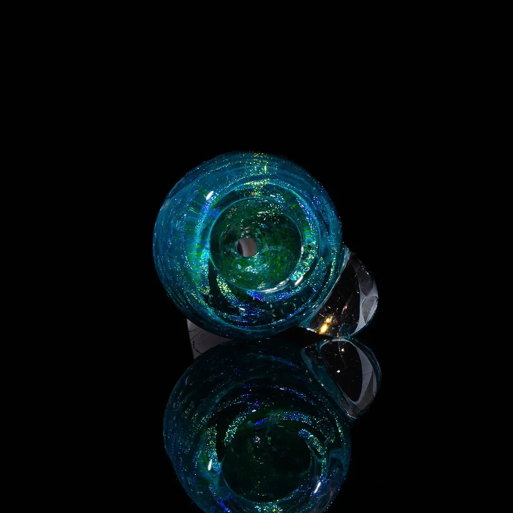 Teal blue glass slide bowl with zigzag pattern and reflective black background