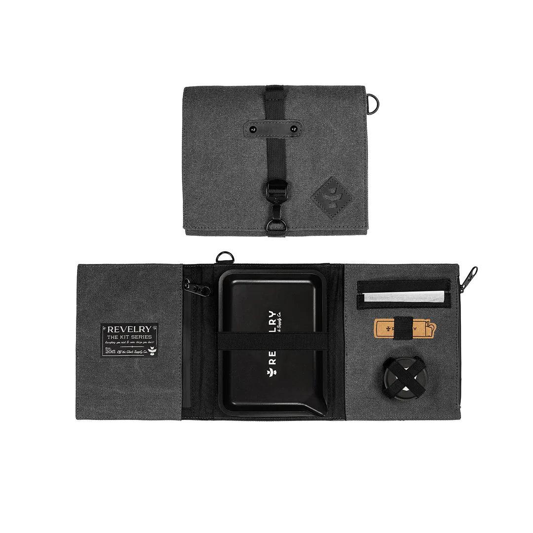 Black portable rolling kit organizer with compartments, tray, and secure strap closure.