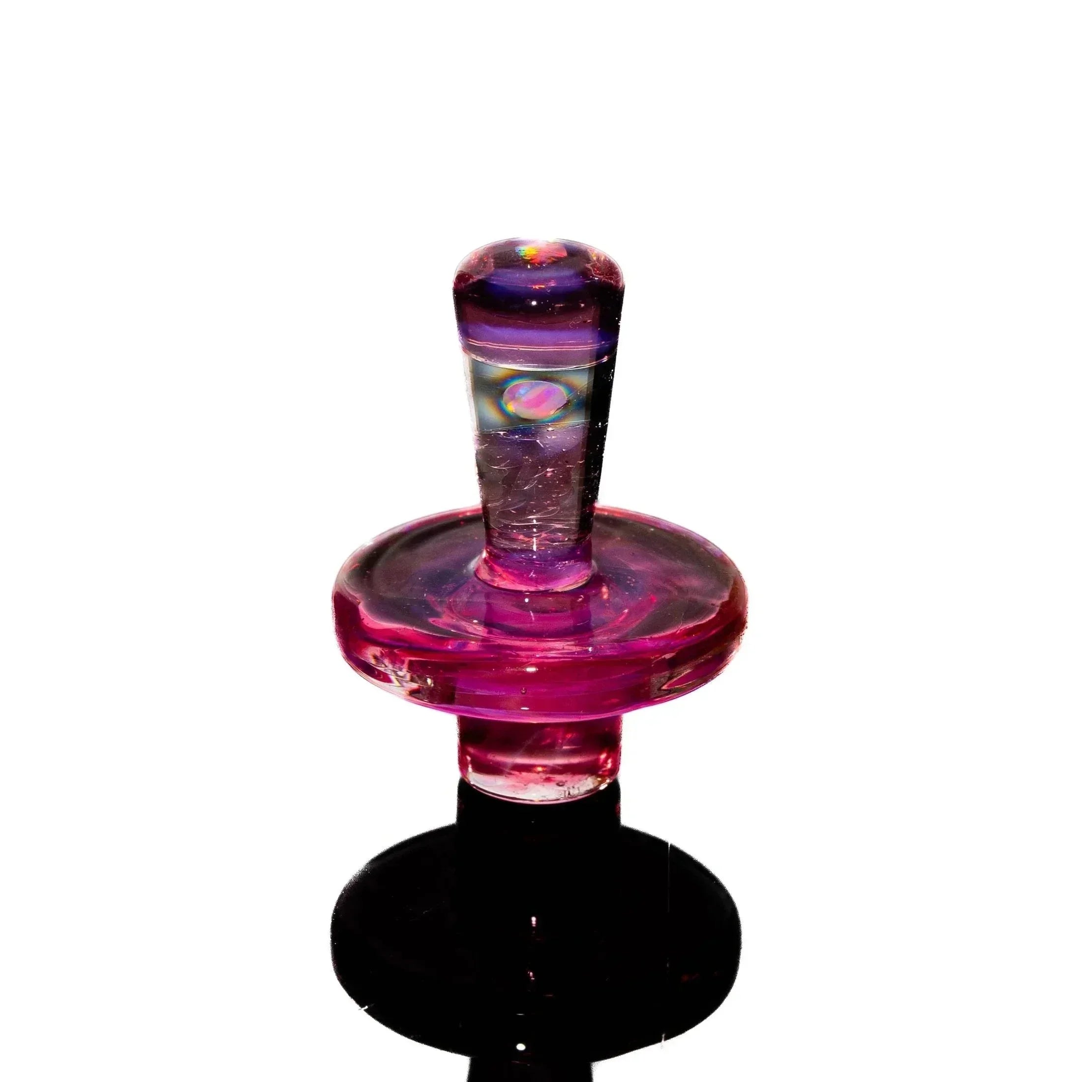 Milky pink glass carb cap with opal accent on a white background