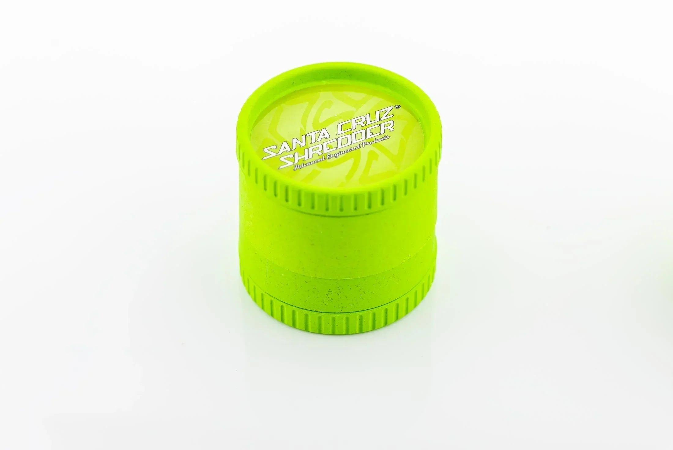 Lime green 4-piece Santa Cruz Shredder herb grinder on white background