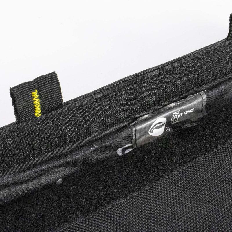 Close-up of black zippered carrying case with yellow stitching and inner label