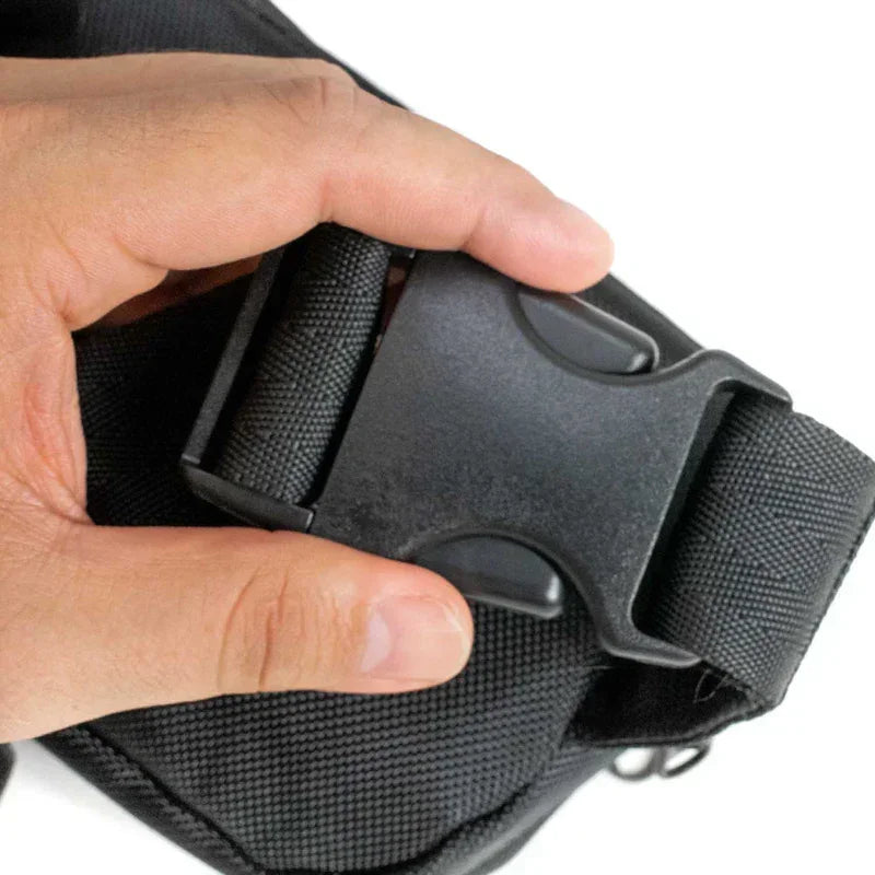 Close-up of hand holding black nylon bag with plastic buckle
