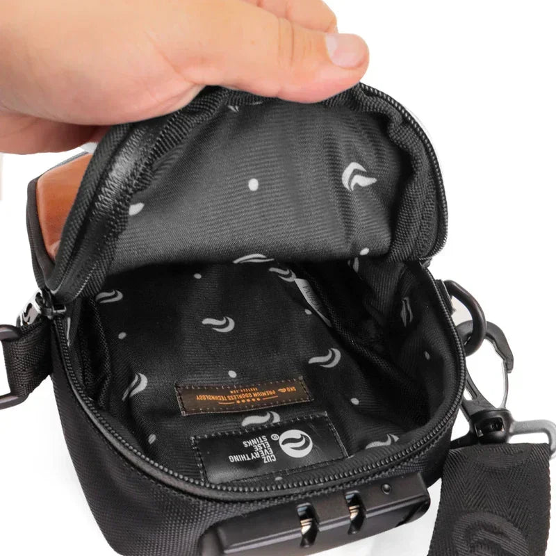 Hand opening small black zippered smell-proof pouch with patterned interior and lock