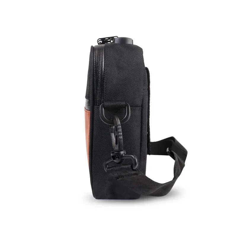 Side view of a black and orange crossbody pouch with adjustable strap and zipper