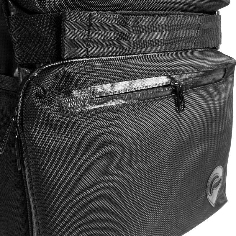 Close-up of black travel bag pocket with zipper and textured fabric detail