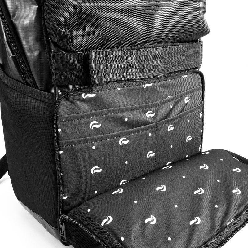 Black backpack with padded interior, multiple pockets, and white patterned lining