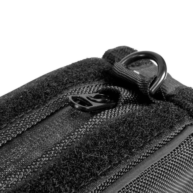 Close-up of black travel pouch zipper and D-ring on durable fabric case