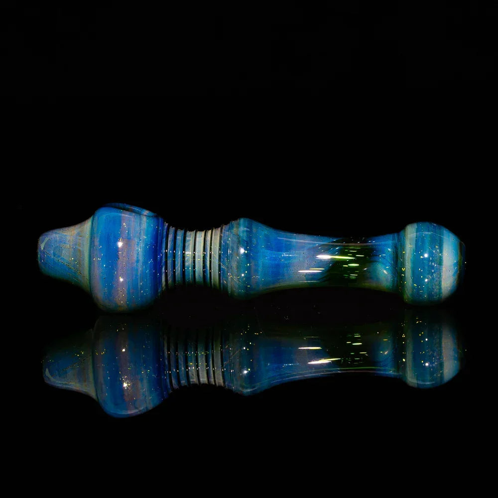 Handblown silver fume green glass spoon pipe with multiple holes on black background