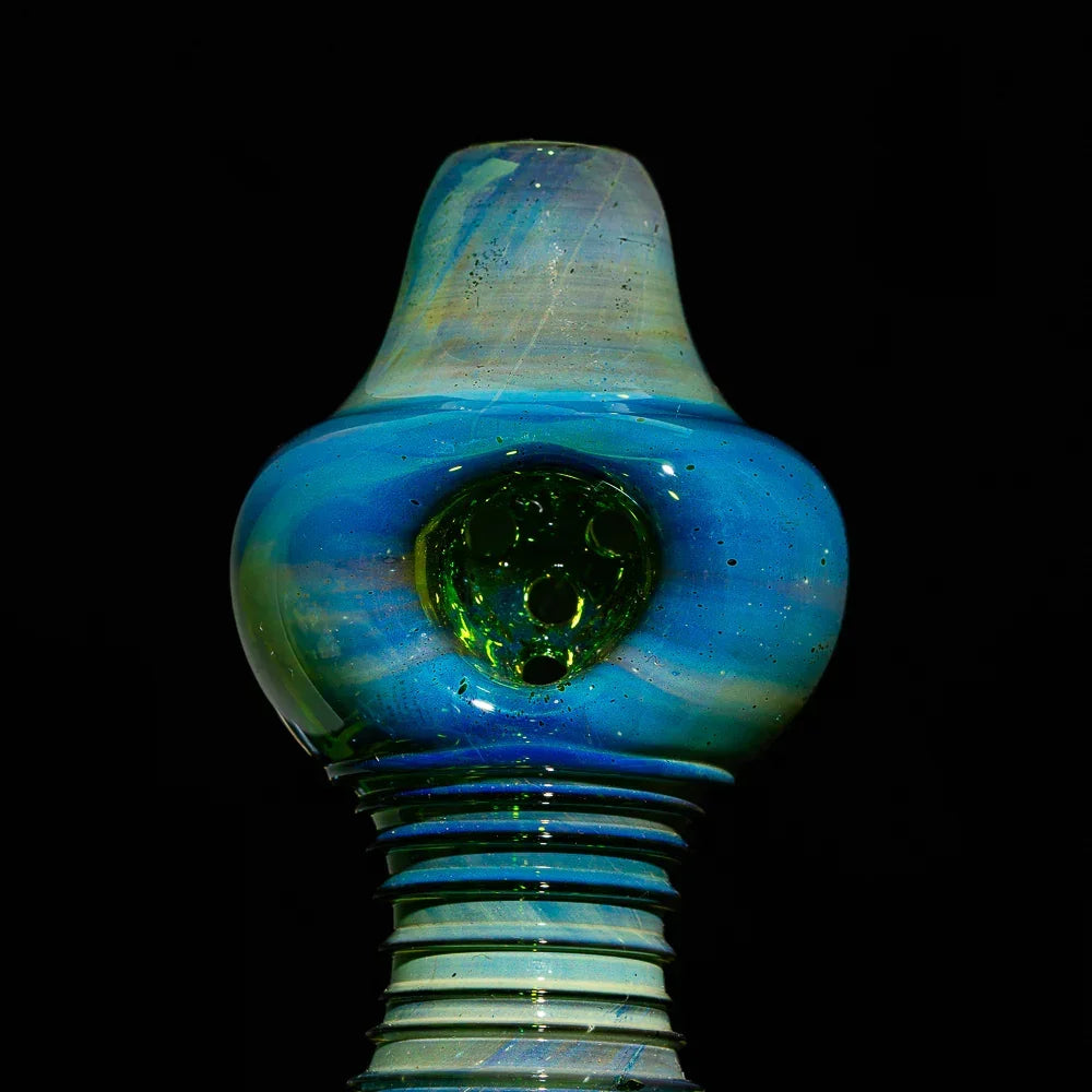 Silver fumed glass spoon pipe with transparent green multi-hole design on black background
