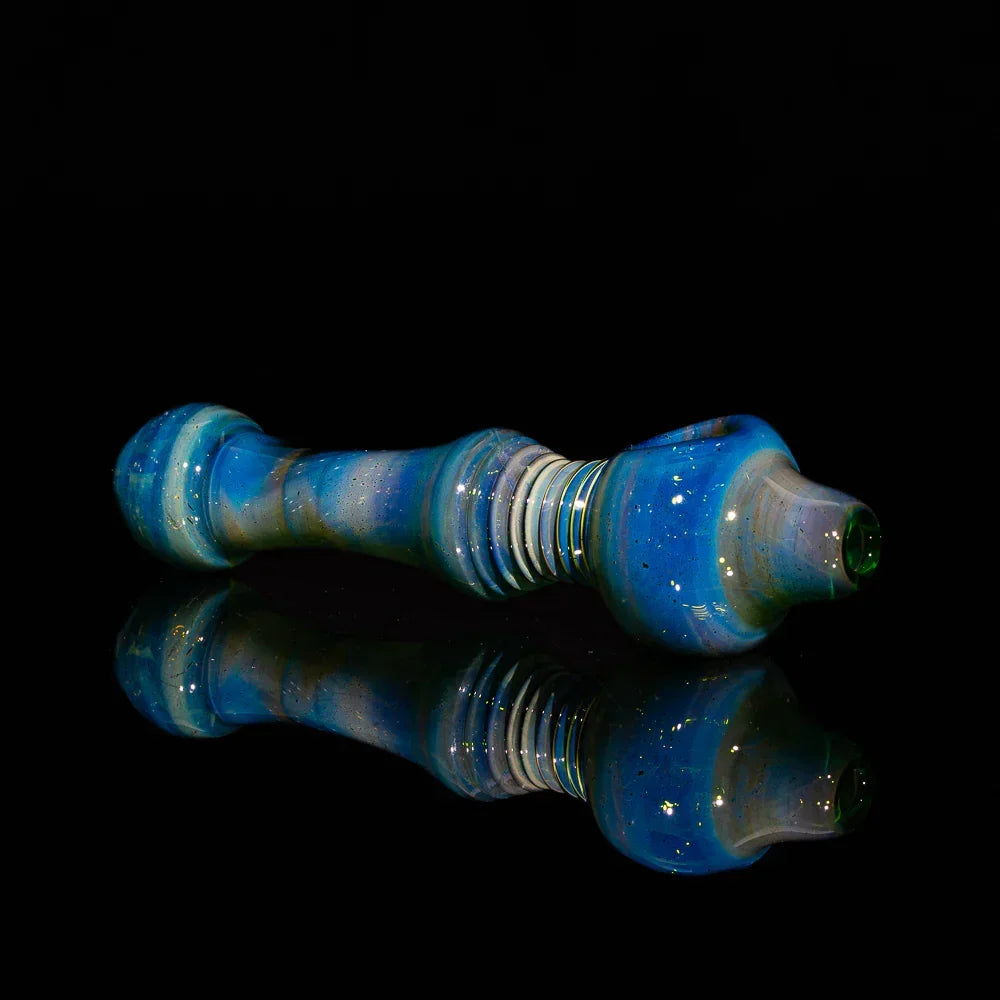 Silver fumed glass spoon pipe with transparent green and blue tones, multi-hole bowl on black background