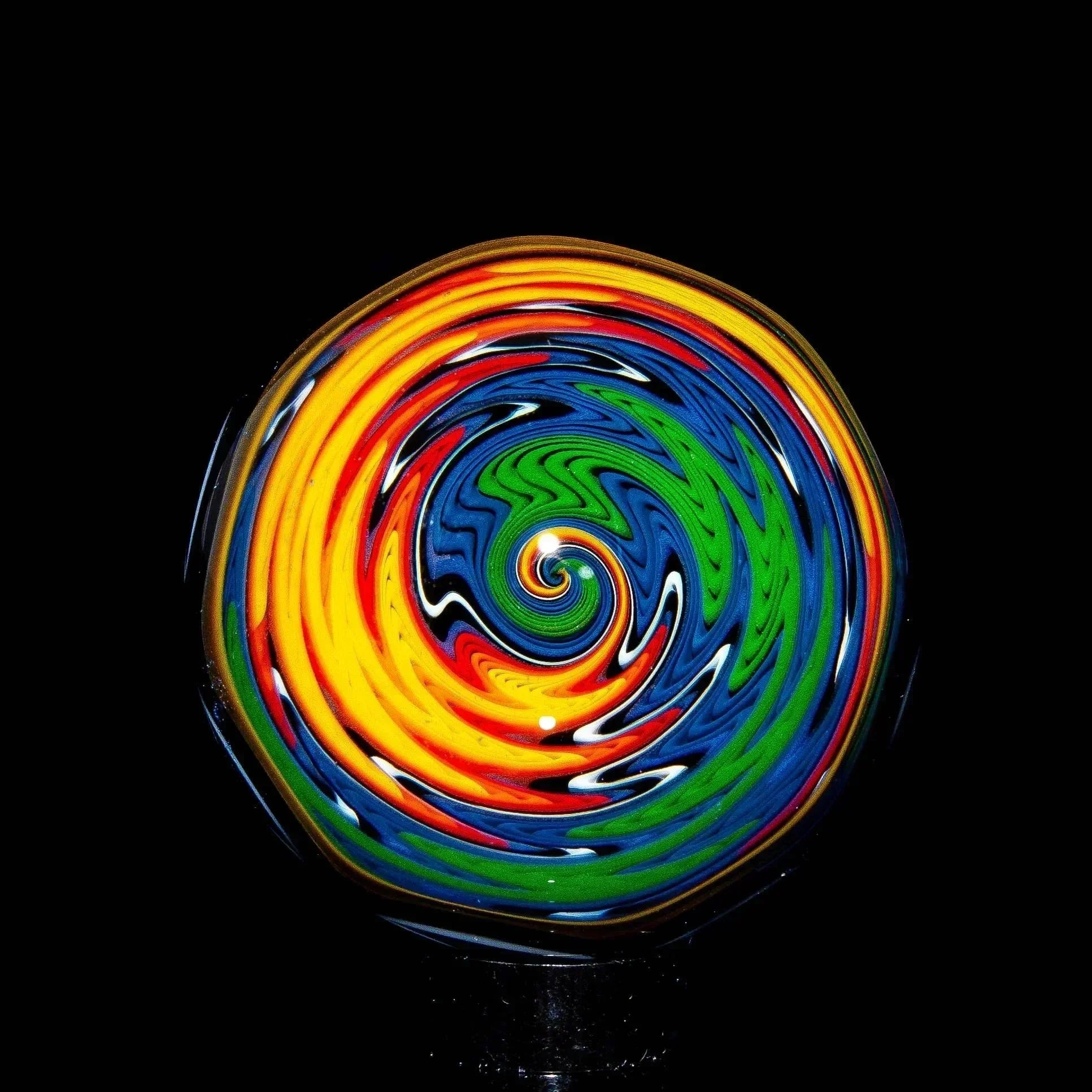Colorful wig wag glass marble with spiral rainbow pattern on black background