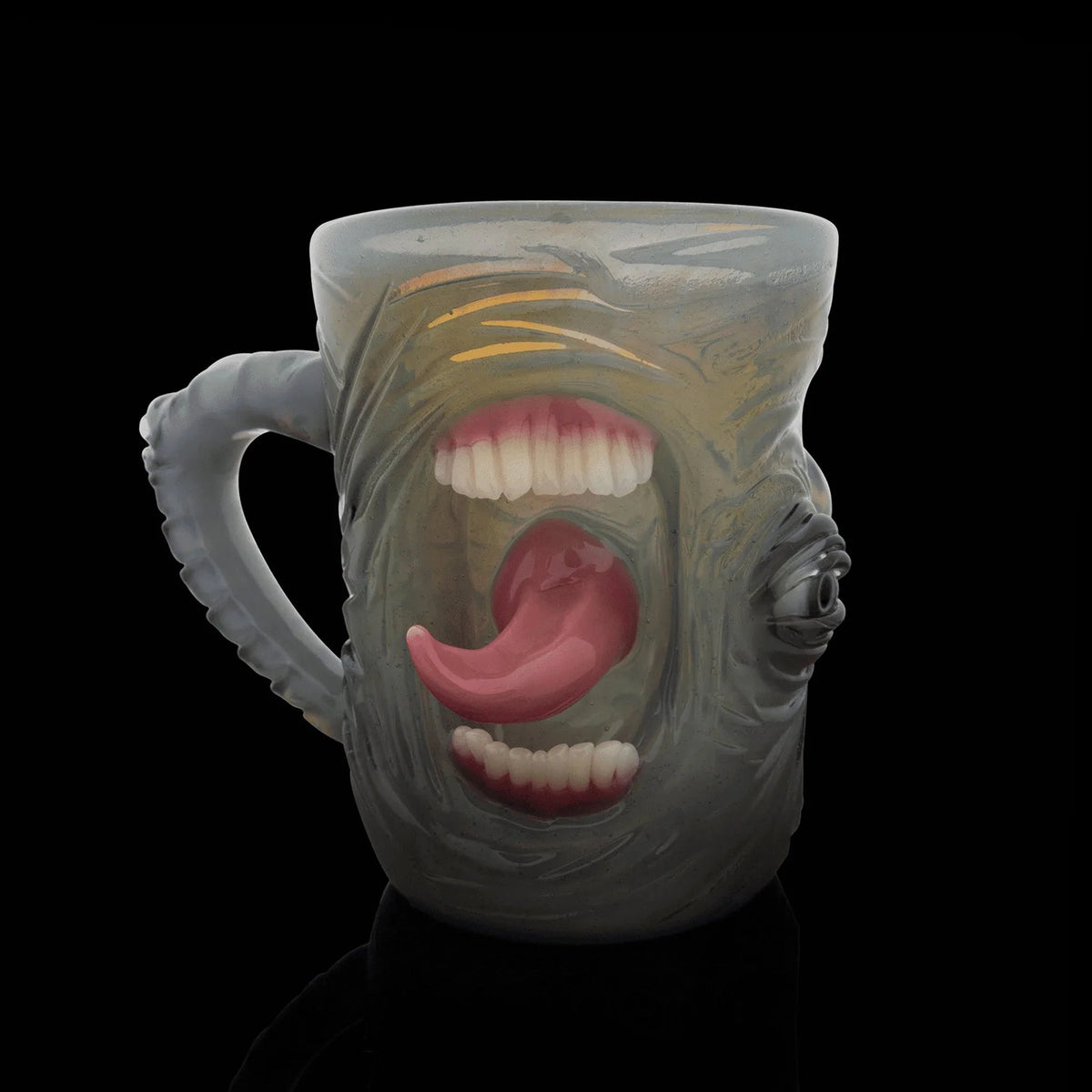 Handcrafted glass mug with surreal face design, featuring mouths and a 3D tongue on pastel body.