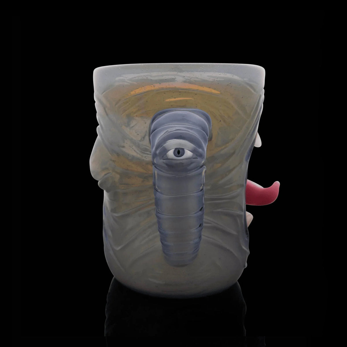 Handmade pastel glass mug with sculpted face, blue nose, and protruding pink tongue