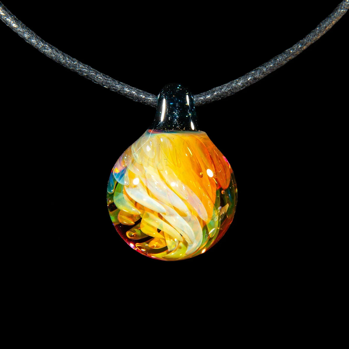Colorful glass implosion marble pendant with swirling orange and yellow patterns on cord