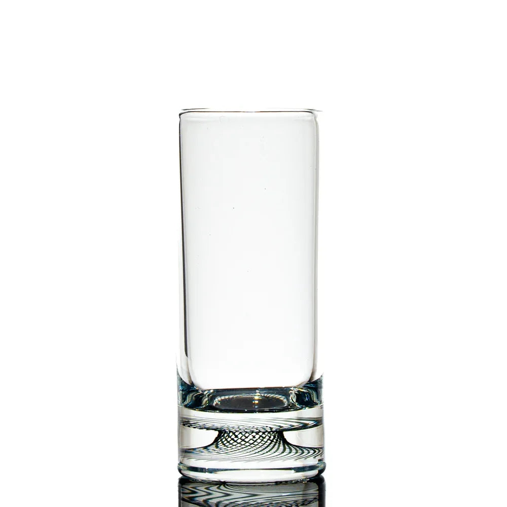 Hand-blown glass shot glass with intricate black spiral pattern on the base, clear body