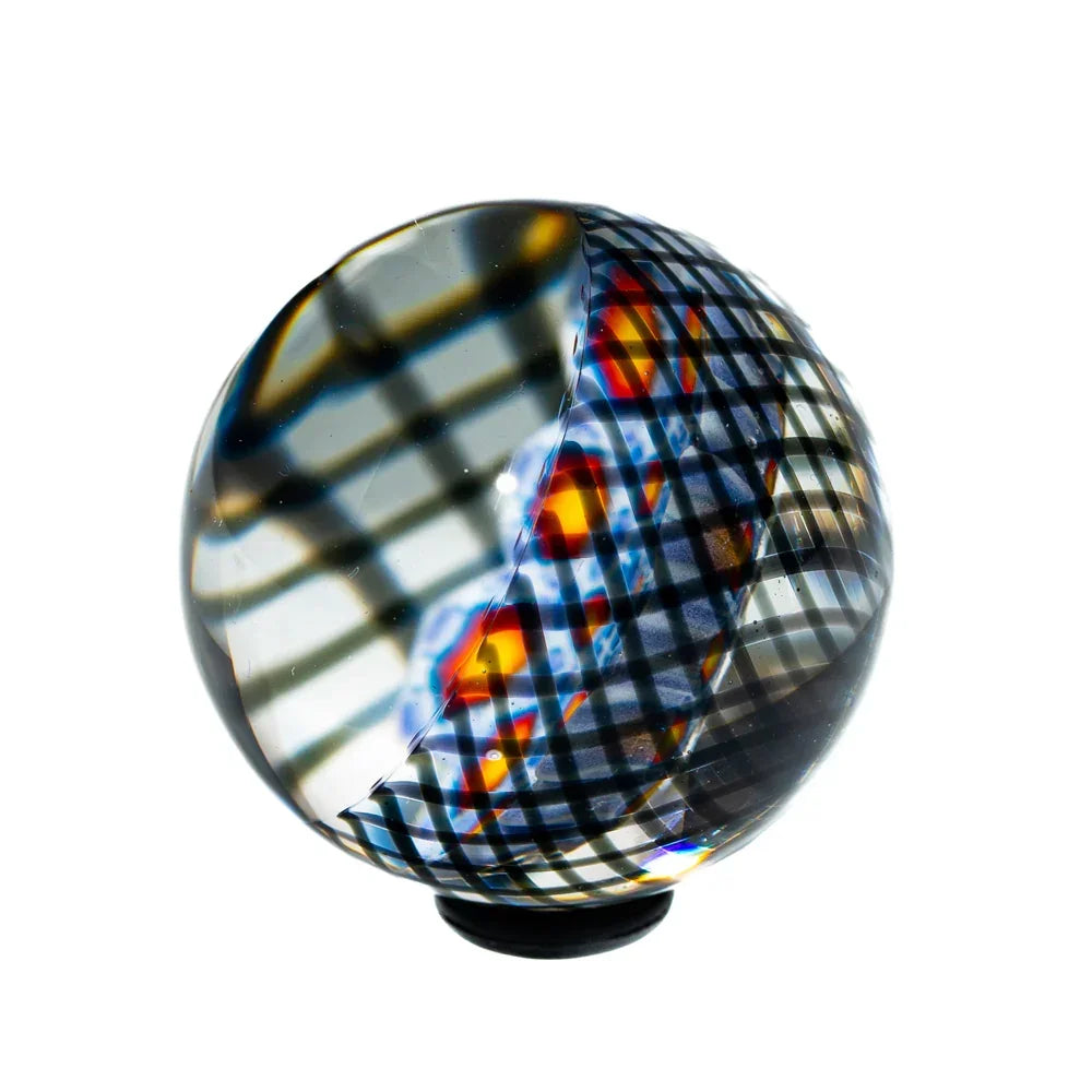 44mm glass marble with intricate hexagonal black, red, and blue grid pattern on white background