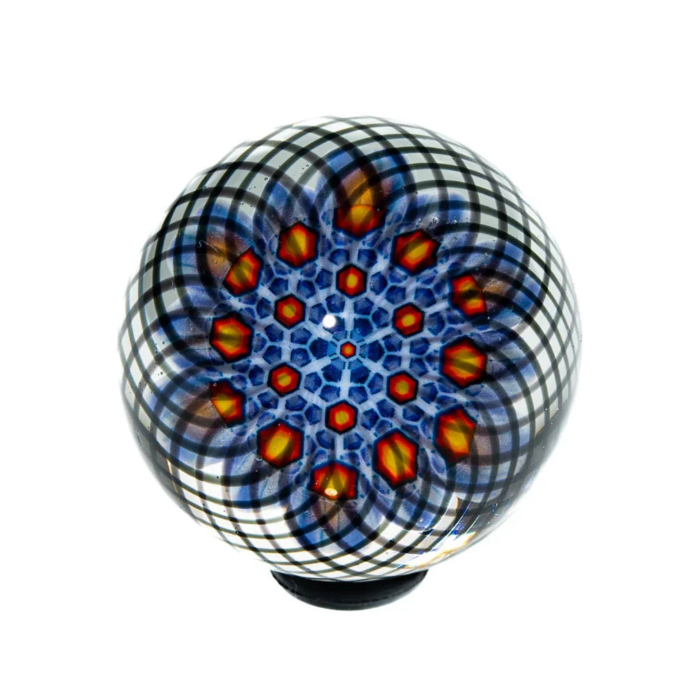 Handcrafted 44mm glass marble with vibrant black, blue, and orange geometric pattern