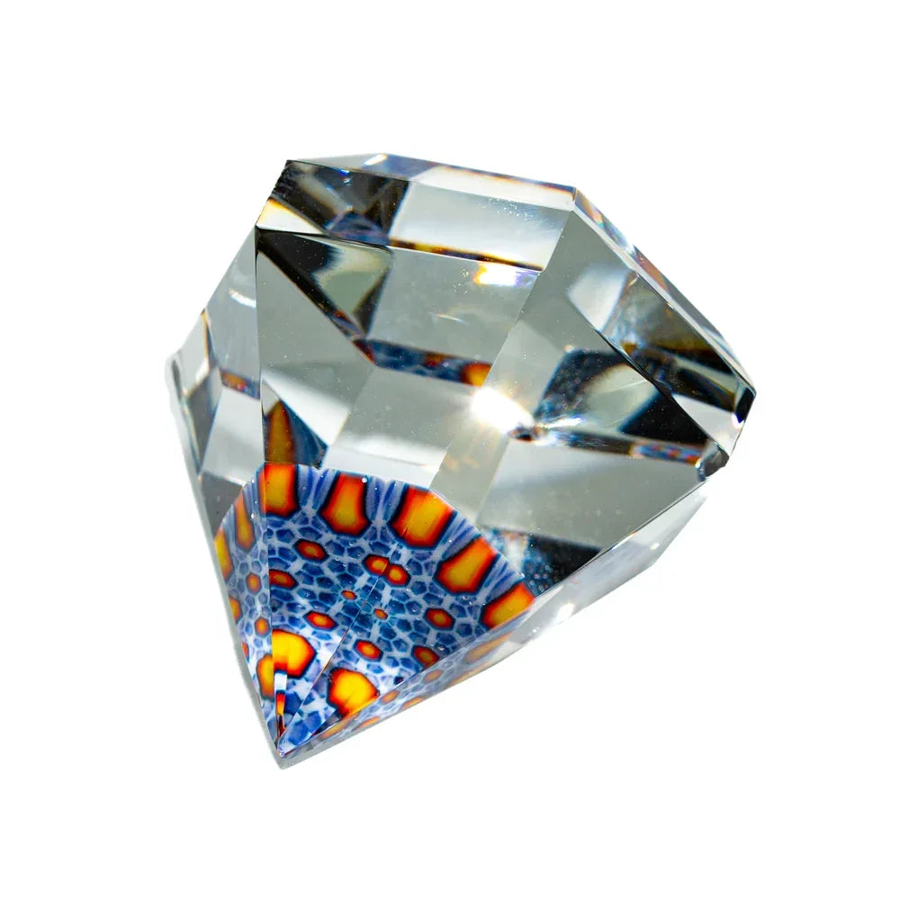 Faceted clear glass gem with vibrant blue and orange honeycomb pattern inside