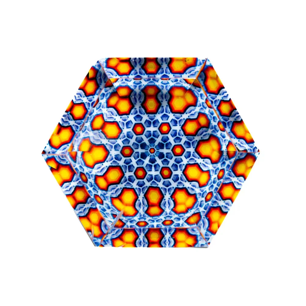 Hexagonal glass art with intricate blue and orange geometric pattern