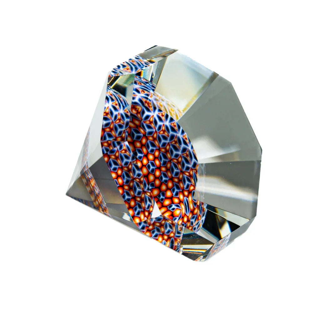 Faceted glass art gem with colorful geometric pattern, clear and reflective surfaces