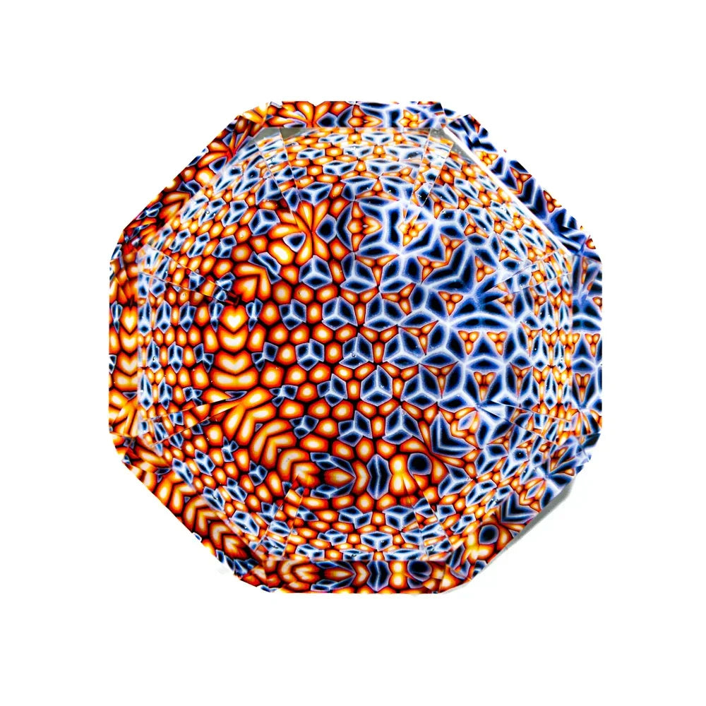 Colorful geometric glass art piece with intricate orange, blue, and white patterns