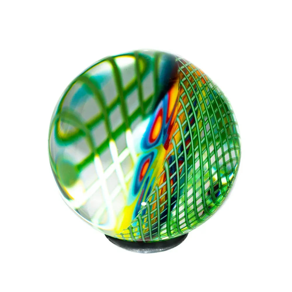 Colorful glass marble with green lattice, rainbow patterns, and intricate artisan design