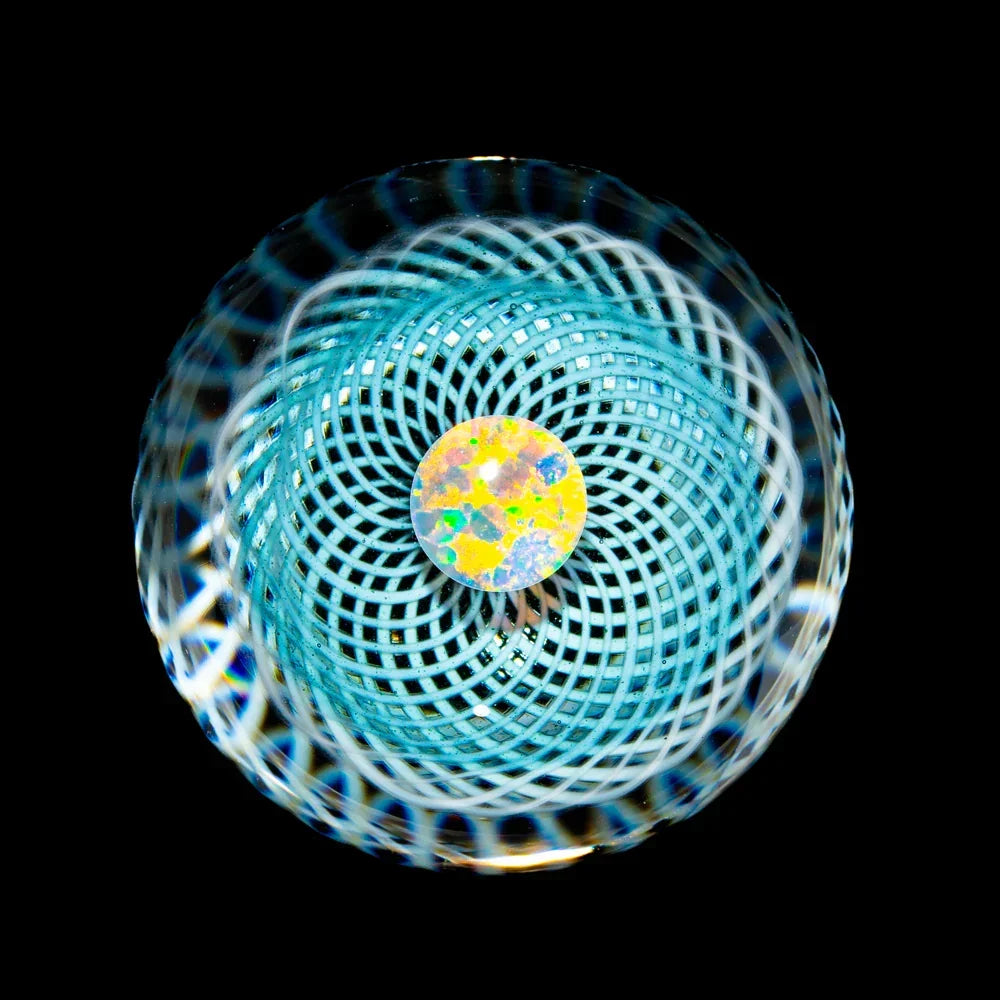 Handcrafted glass marble with intricate blue spiral pattern and opal centerpiece on black background